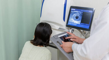 Patients and doctors using visual acuity and fundus examination equipment in ophthalmology.
