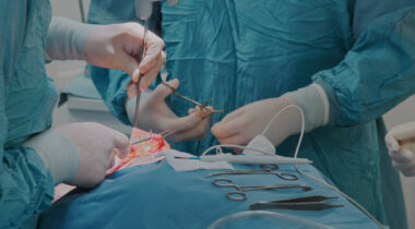 Surgeon makes an operation with the help of a nurse, close-up